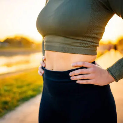 Women showing her gut health after a run outside in the sunrise