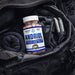 Andriol® testosterone support dietary supplement bottle inside gym bag with workout gear by Hi-Tech Pharmaceuticals